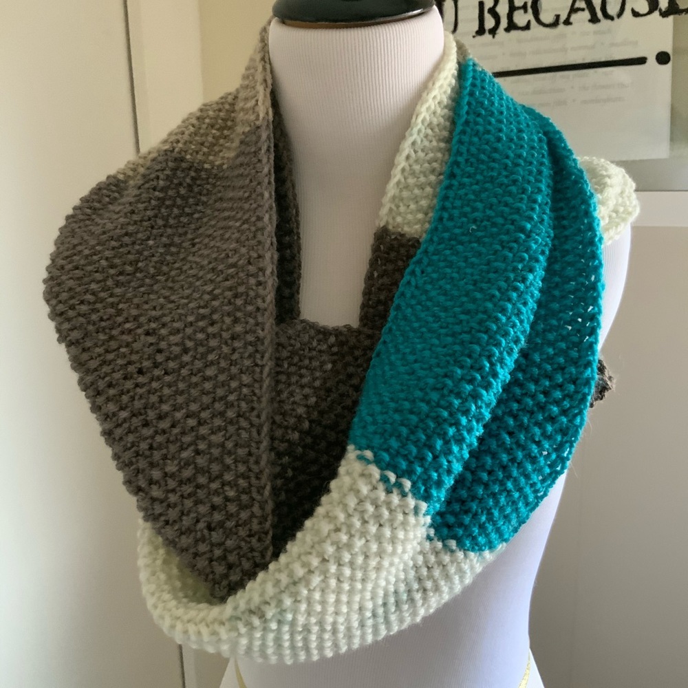 Hand knit scarf/cowl in shades of teal and gray.